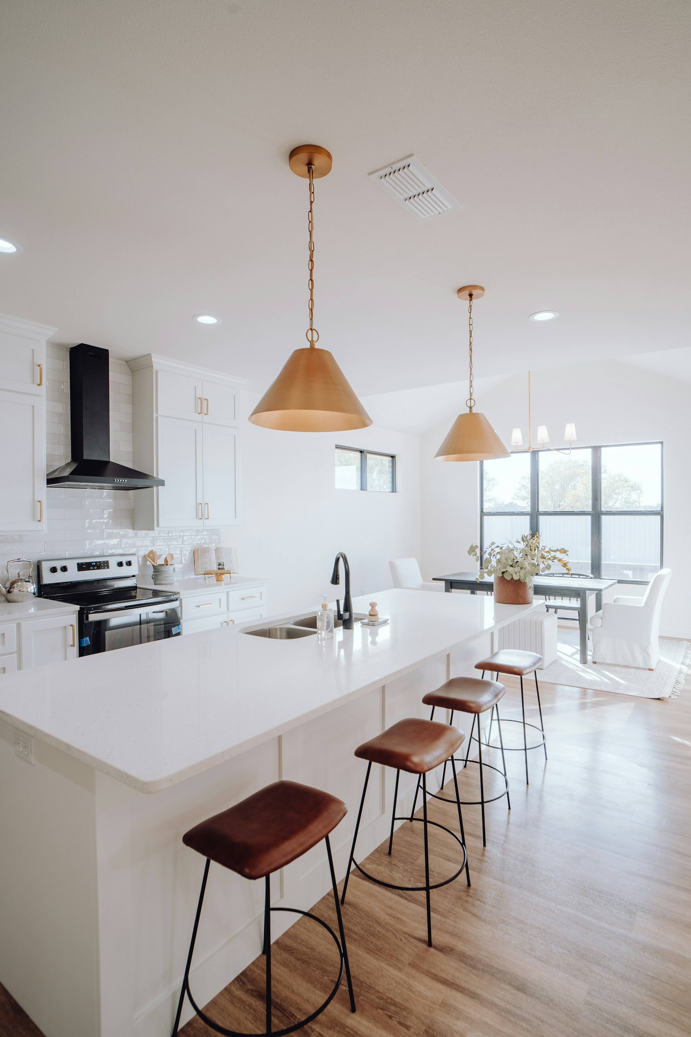 Clean, updated kitchen with an island and bar stools